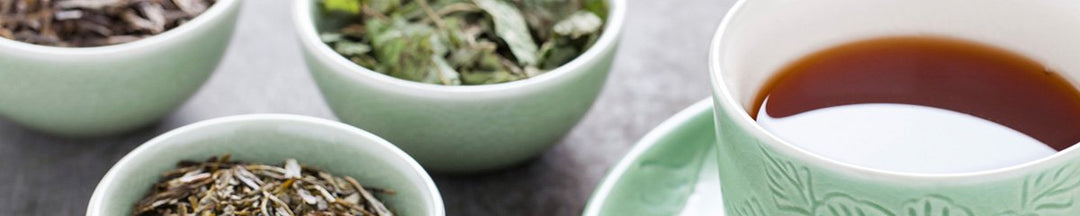 Tea leaves, next to a cup of tea